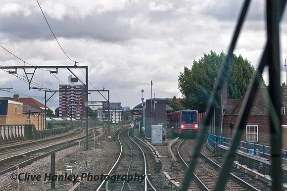Heading east on the Docklands Light Railway (DLR) approaching Shadwell. Fenchurch Street mainline runs alongside.