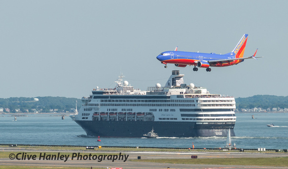Holland America Line MS Veendam sets off for Montreal while a Southwest airlines jet flies over.
