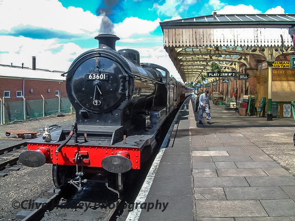 Robinson Class O4 no 63601 prepares to depart from platform 2. Note the buildings over the fence.