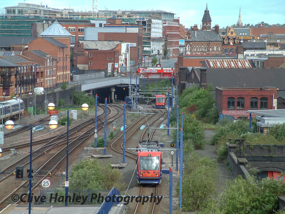 Trams to and from Wolverhampton can be seen on the right. The track uses the old GWR mainline.