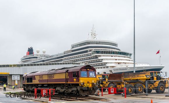 Class 66 no 66164 stands adjacent to the QEII terminal where Queen Elizabeth is moored.