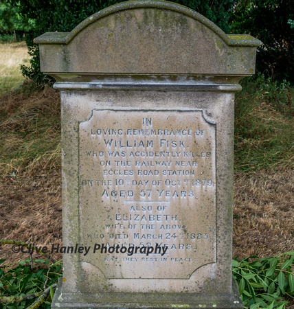 A gravestone memorial to William Fisk - killed on the railway near Eccles Road station in 1879.
