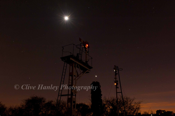 The signals to the south of Quorn illuminated by moonlight. The planet Jupiter hangs over the top of the tree.