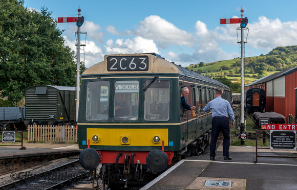 At Winchcombe the DMU is arriving and the driver hands over the single line token.