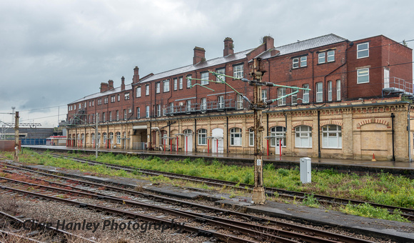 The backside of Crewe station. Literally. Note the overhead cables on an old canopy support.
