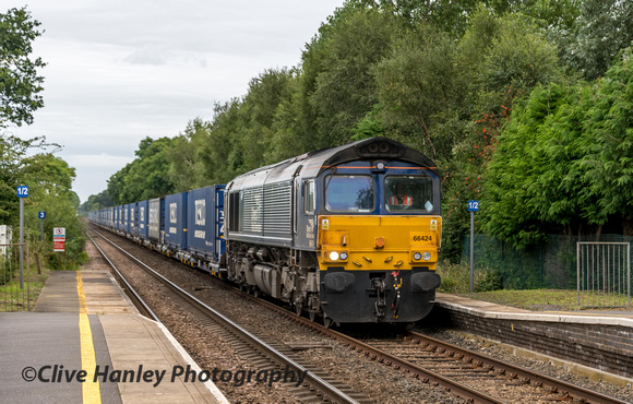 Direct Rail Services Class 66 no 66424 heads south through Prees station with the Tesco Binliner train.