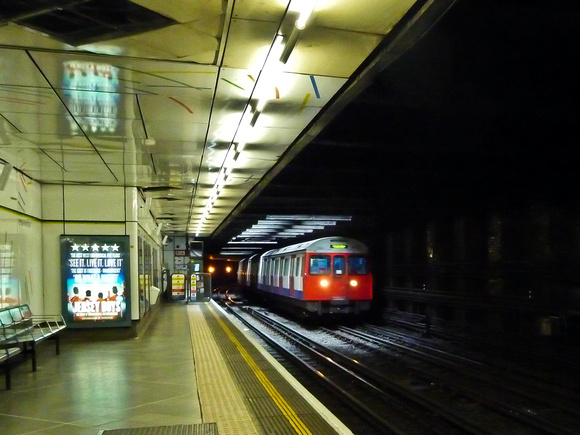 A Circle Line underground train arrives at Embankment station