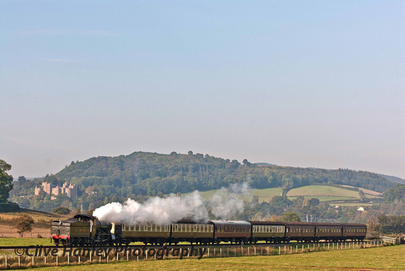 GWR Mongrel Mogul no 9351 brings the first passenger train of the day towards Blue Anchor. Dunster Castle is in the background.