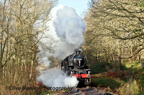 The Flying Pig - Ivatt mogul 2-6-0 no 43106 appears to have a cylinder drain cock stuck open as it passes through the woods at Northwood Lane.