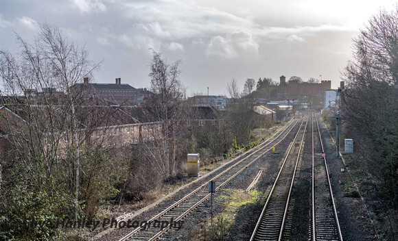 A view back to the station from the bridge at Coton Hill with unit 150229 heading to Manchester Piccadilly