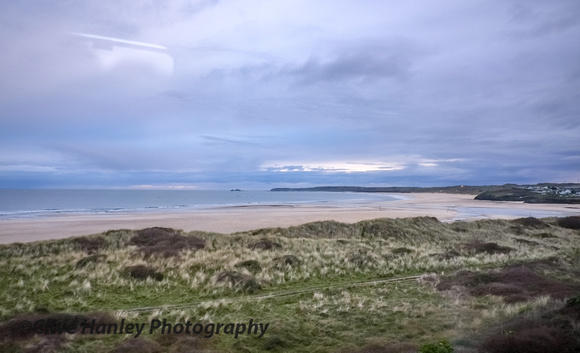 A view through the window of the train towards Godrevy Lighthouse.