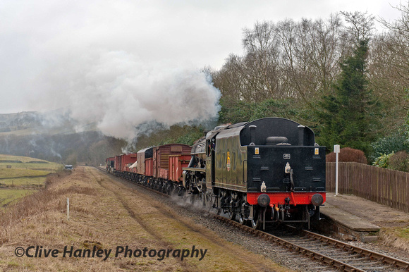 Stanier Black 5 no 45407 (now named Lancashire Fusilier) heads the freight through Irwell Vale.