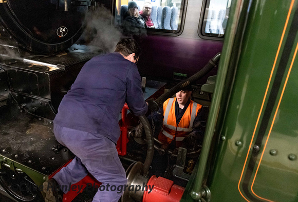 Alistair Meanley assists in connecting the vacuum pipes between the locos.