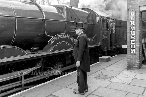 The loco propells the stock down the platform under the watchful eyes of the fireman and station master