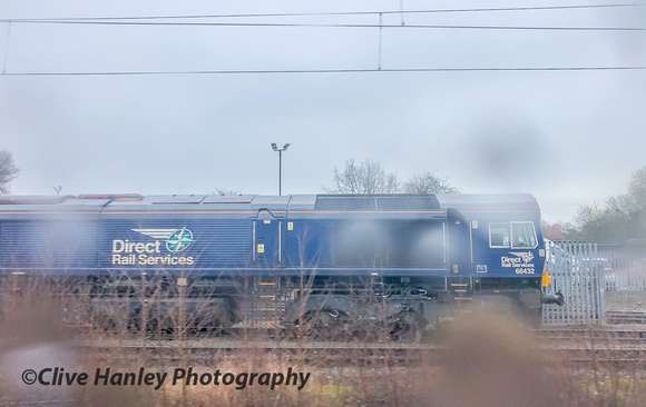 Rain spots on the coach window made it difficult. Class 66 no 66432 was the first in a line of locos on arrival at Crewe