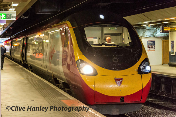 A Pendolino sits in the gloom of New Street.