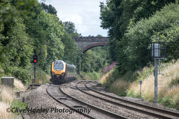 A XCountry Voyager unit heads south towards the overbridge at Shrewley