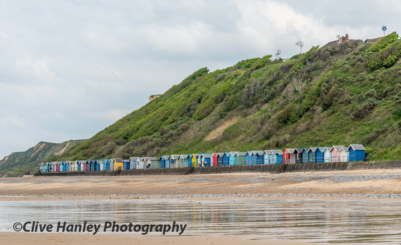 A colourful row of beach huts.