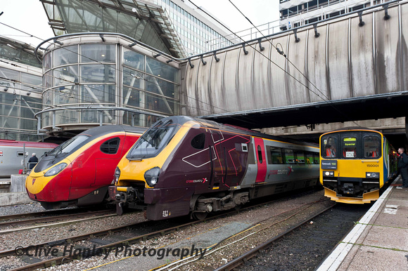 150001 stands at Birmingham New Street alongside Voyager 221128 and a Pendolino