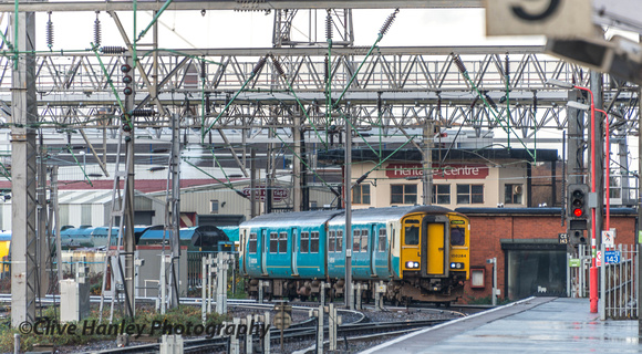 The two car "Arriva Trains Wales"  service from Chester rounds the curve past Duchess of Sutherland in the Heritage Centre
