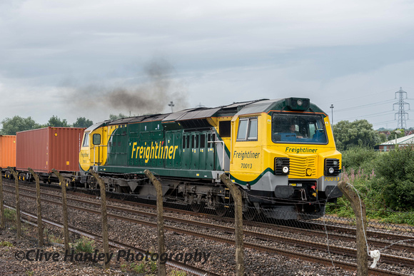 A butt ugly Freightliner loco no 70013 powers around the curve to the east of Didcot with a container train.