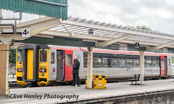 The guard stands awaiting any passengers before departure from platform 5. The 10.09 to Swansea is formed of unit 153327