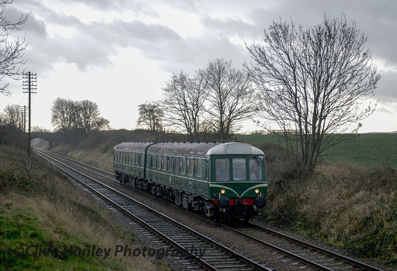 Rain had started to fall as the DMU approaches the A6 by-pass bridge - Epinall Way
