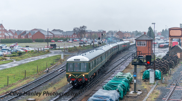 In miserable rainy weather the staff transport DMU sets off from Kidderminster