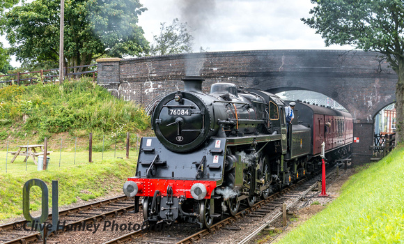 Departure from Weybourne of the 11.20 service from Sheringham with Standard 4 no 76084