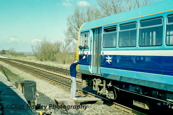 The signalman is passing the single line token to the driver as the train departs Rufford. The track is now singled all the way to the WCML. At this time (I think) it became double again at Midge Hall