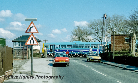 The "Pacer" departs north over the level crossing at Rufford.