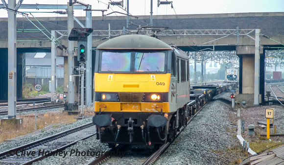 At Nuneaton station Class 90 no 90049 heads north with a container train.