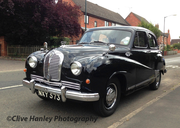 A beautifully restored "Austin of England" sits at the roadside.