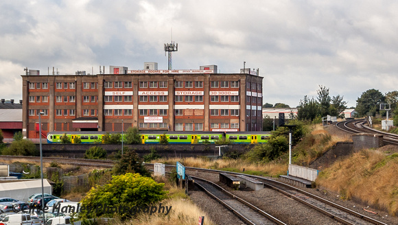 A service train heads past on the mainline towards Birmingham Moor Street station.