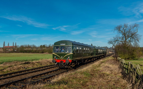 The DMU passes the field at Woodthorpe