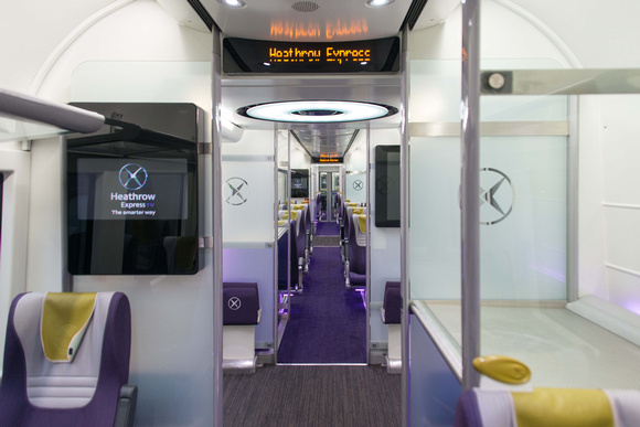 The interior of a Heathrow Express carriage. Luggage racks to the right, comfortable seating in excess.