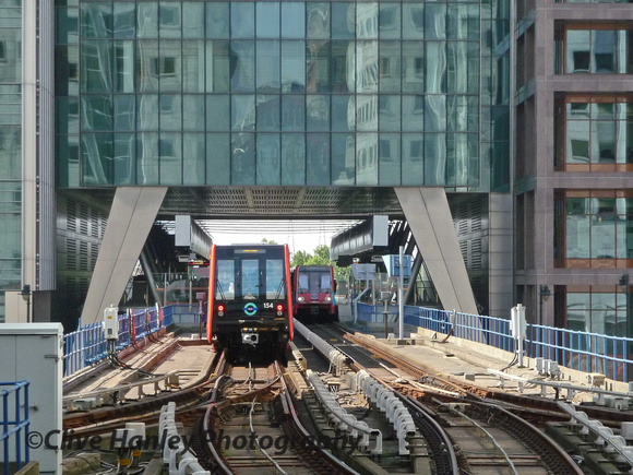 Unit 154 heads away from Canary Wharf and is entering Heron Quays station