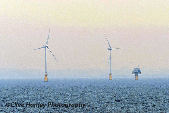 The offshore substation alongside two turbines.