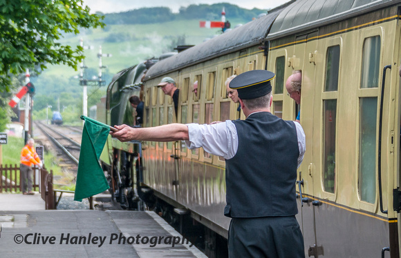 back at Toddington the flag is waved by the train guard to indicate departure. by 35006.