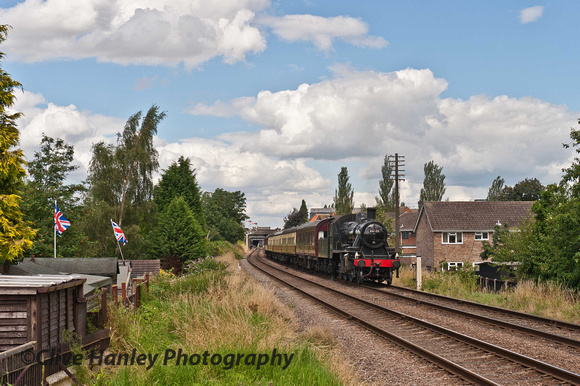Events in 2012 have made people a lot more patriotic. Union Flags proudly displayed on the garden shed as 46521 passes.
