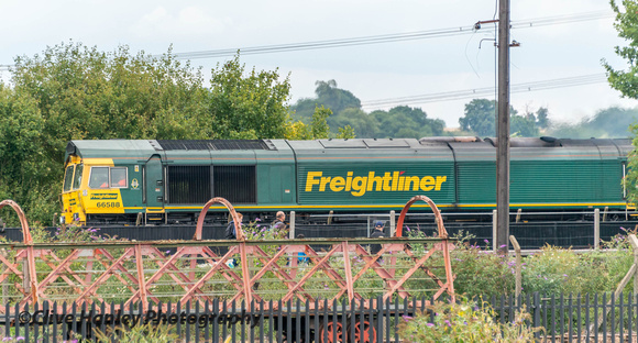 Freightliner Class 66 no 66588 heads around the east curve to head north with a freight.