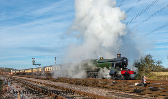 In a cloud of steam caused by the driver opening the cylinder drain cocks 6990 sets off towards Rothley.