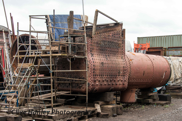 Two boilers lie outside the works. Nearest is from Fowler 4F no 44027 while beyond is 6984 Owsden Hall's boiler.