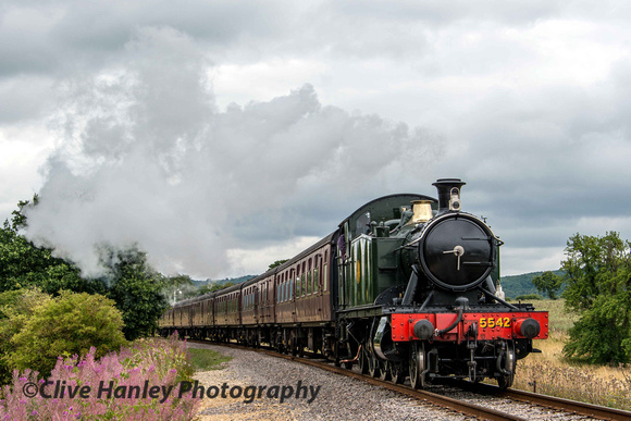 GWR small Prairie 2-6-2 tank loco no 5542 rounds Chicken curve as it approaches Winchcombe station.