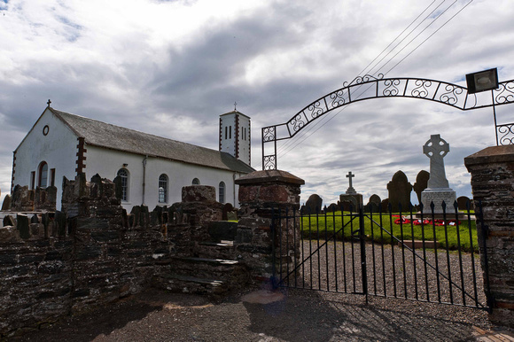A stone built stile at the entrance to Jurby church