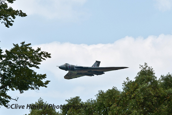 XH558 appears between the trees at Goodwood