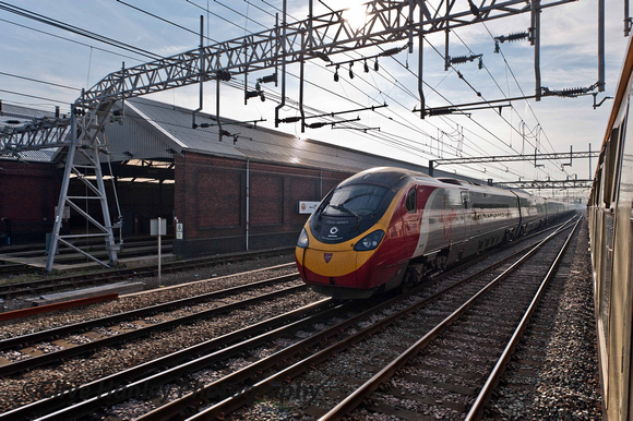 A Pendolino overtakes our train as we slowly approach the platform at Crewe.