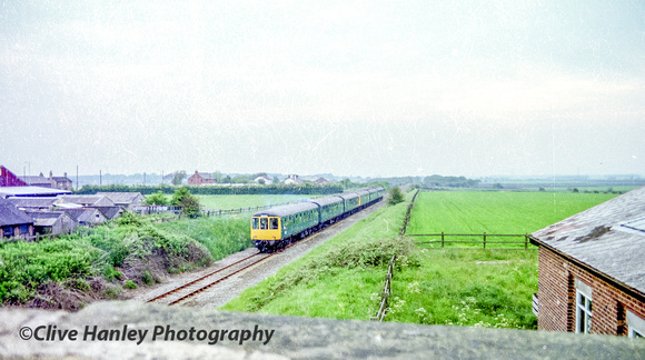 A 6 car "Special" DMU heads north towards Rufford. The church can be seen above the 3rd carriage.