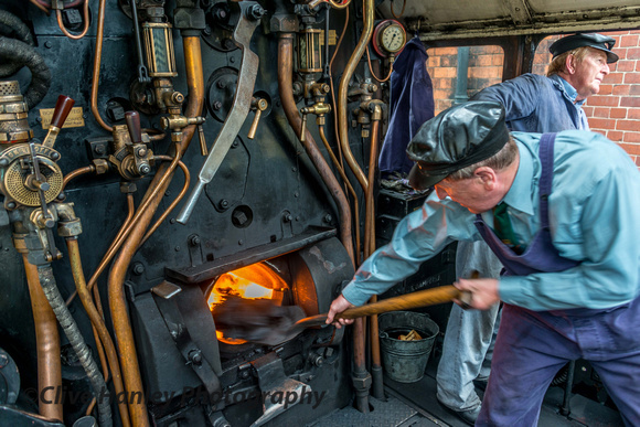 George throws a few shovels of coal into the firebox on 48624