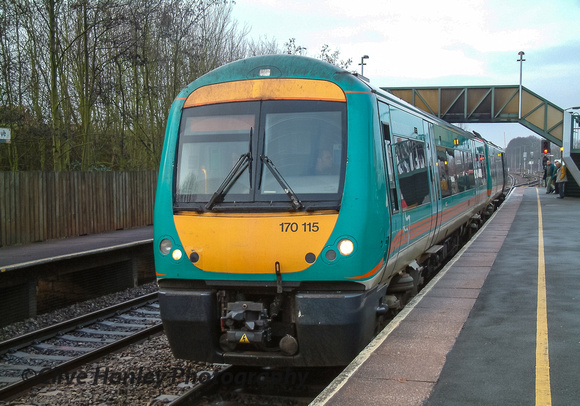 At Bromsgrove station in the morning unit 170115 stops to pick up passengers.